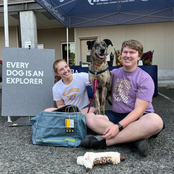 Two humans with dog at RAD Event.