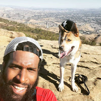 Marcus takes a selfie with Batman atop a rocky ridge.