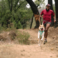 Marcus trail runs with dog.